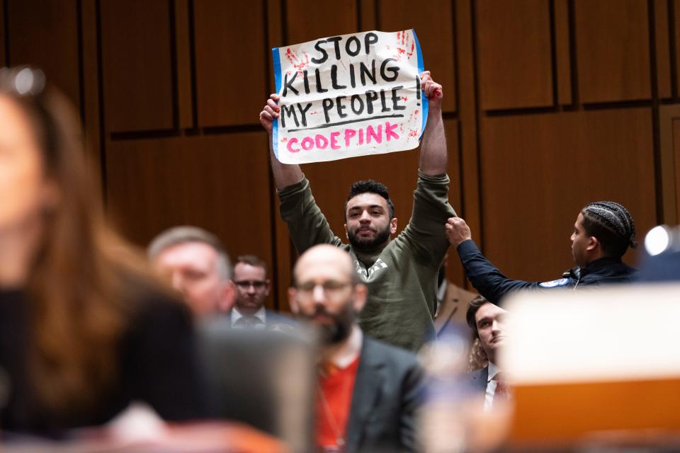 A pro-Palestine protestor is escorted out of the room as the Senate Select Committee on Intelligence holds a hearing on worldwide threats on March 11, 2024, in Washington.