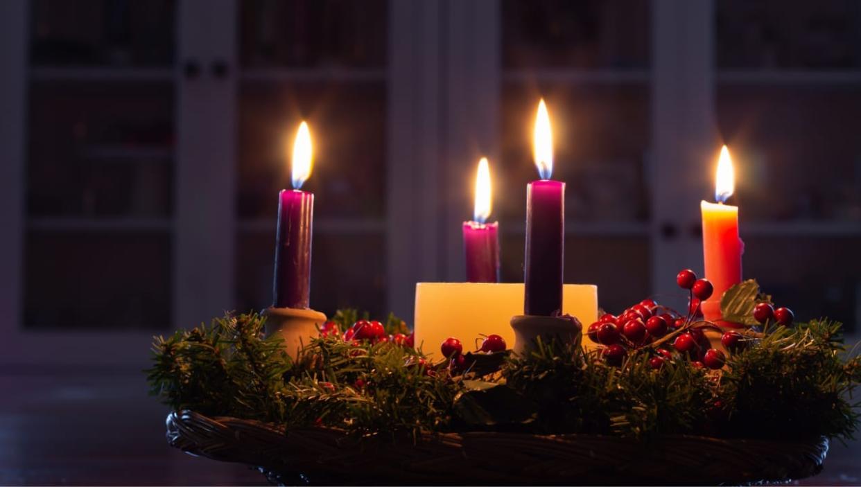 The four Advent candles, three purple and one rose, represent the four weeks of the religious season.