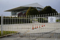 The grandstand at the shuttered Arlington International Racecourse is seen from a parking lot in Arlington Heights, Ill., Friday, Oct. 14, 2022. The Chicago Bears want to turn the Arlington Heights site, once a jewel of thoroughbred racing, into a different kind of gem, anchored by an enclosed stadium and bursting with year-round activity — assuming a deal with Churchill Downs Inc. to buy the land goes through. (AP Photo/Nam Y. Huh)