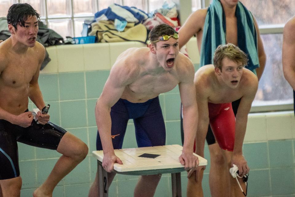 Rob Alexy (center) cheers on the Delbarton 200-yard freestyle relay during the Morris County Boys Swimming Championships at Morris County Community College on Saturday Jan. 22, 2022.