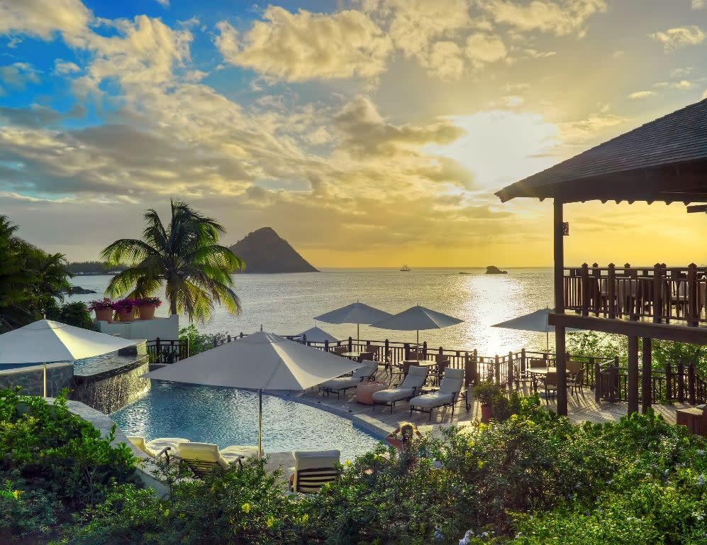 a resort with a pool and umbrellas