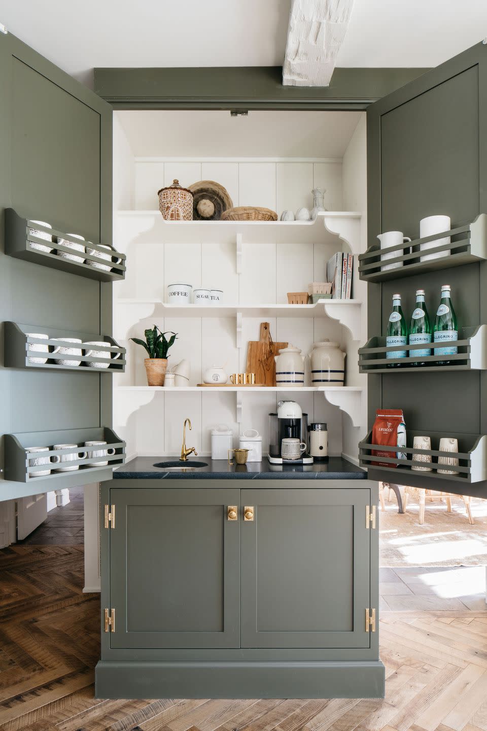 a kitchen cupboard with a built on coffee station