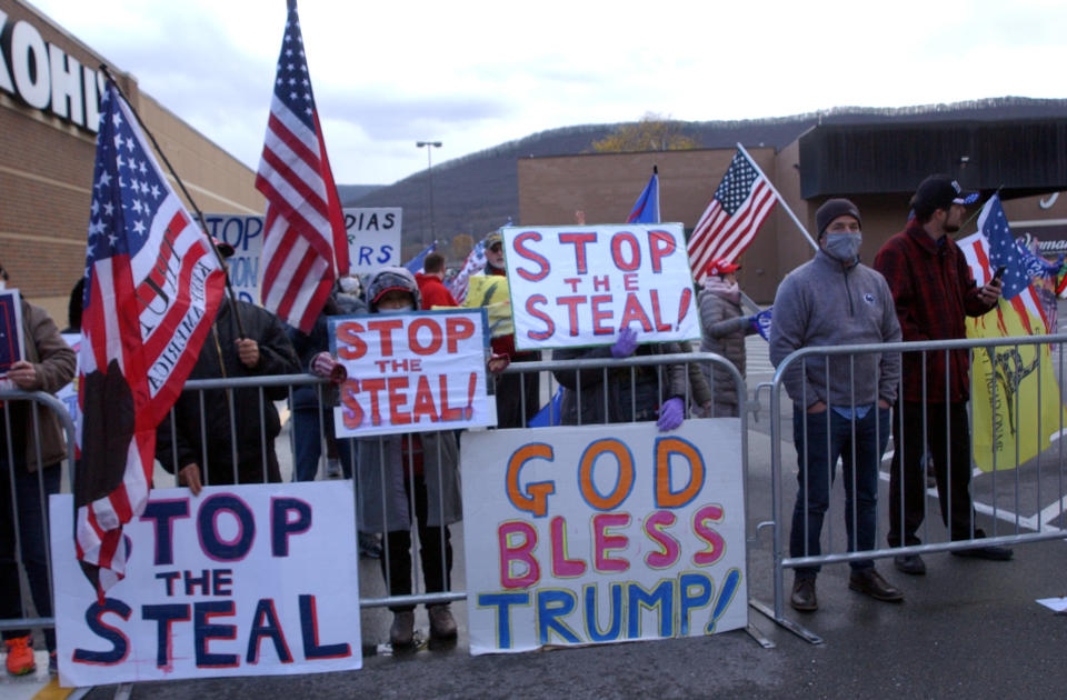 Approximately 100 Trump supporters some with flags and signs stood across West Third Street from the Federal Building in Williamsport, Pa., for hours Tuesday, Nov. 17, 2020, chanting such things as ‘Four More Years,’ ‘Black Lives Matter,’ ‘We Want Trump’ and ‘Dead People Can’t Vote.’ Attorneys for the Trump campaign organization inside the Federal Building were arguing why the state and seven county election boards were arguing should not certify the results of the general election because voters across the state were not treated the same. (John Beauge/The Patriot-News via AP)