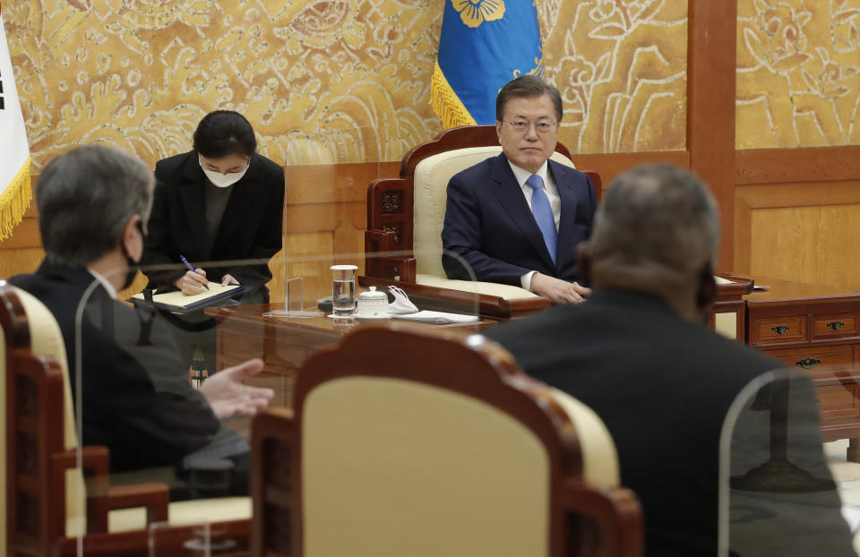 South Korean President Moon Jae-in, center, listens to U.S. Secretary of State Antony Blinken, left, and U.S. Defense Secretary Lloyd Austin, right, sits during their meeting at the presidential Blue House in Seoul, South Korea, Thursday, March 18, 2021. (AP Photo/Lee Jin-man, Pool)