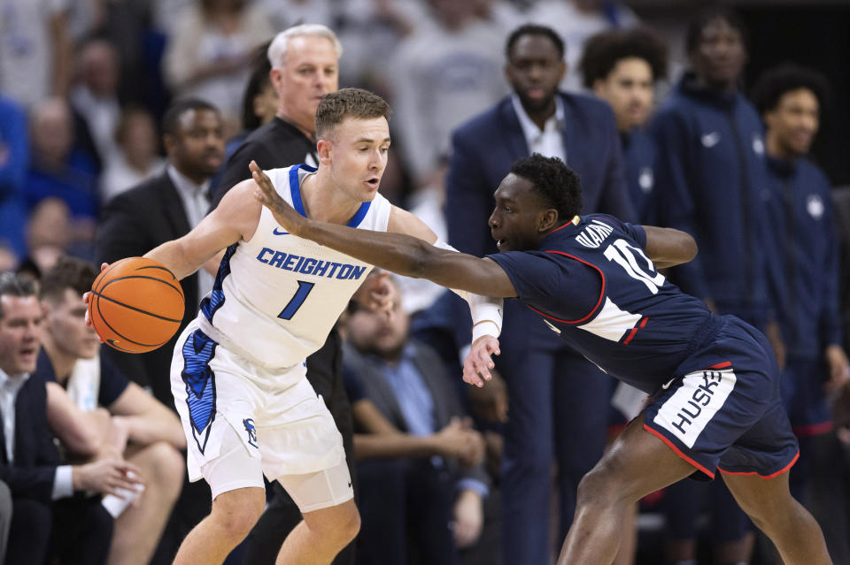 UConn's Hassan Diarra (10) reaches for the ball against Creighton's Steven Ashworth (1) during the first half of an NCAA college basketball game Tuesday, Feb. 20, 2024, in Omaha, Neb. (AP Photo/Rebecca S. Gratz)