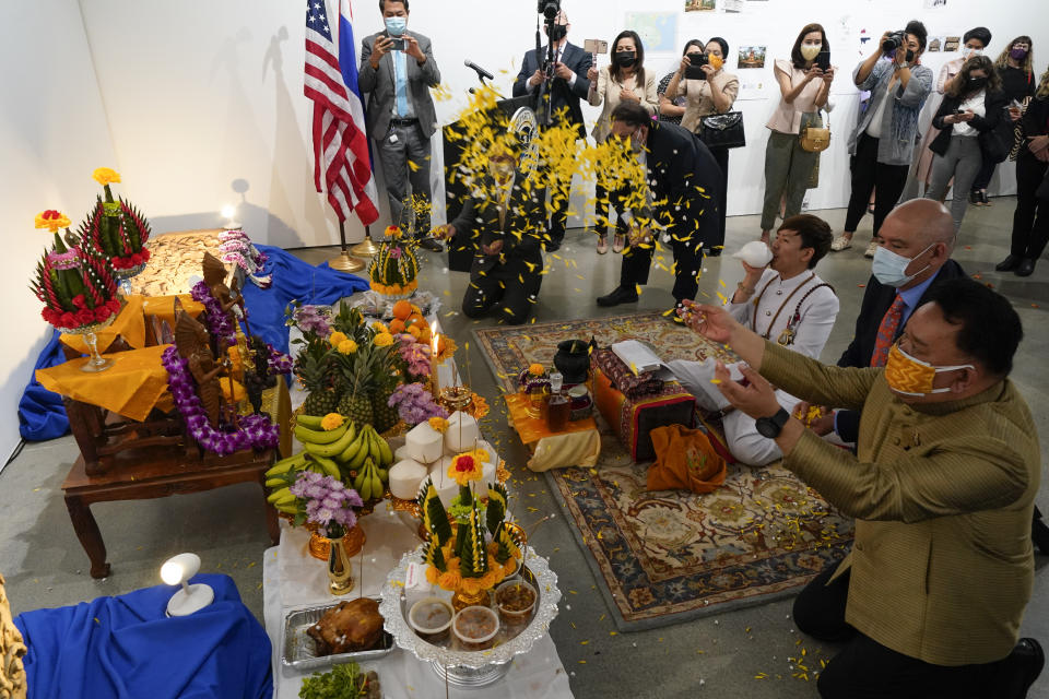 Thai and U.S. officials participate in a ceremony to return two stolen hand-carved sandstone lintels dating back to the 9th and 10th centuries to the Thai government Tuesday, May 25, 2021, in Los Angeles. The 1,500-pound (680-kilogram) antiquities had been stolen and exported from Thailand — a violation of Thai law — a half-century ago, authorities said, and donated to the city of San Francisco. They had been exhibited at the San Francisco Asian Art Museum. (AP Photo/Ashley Landis)