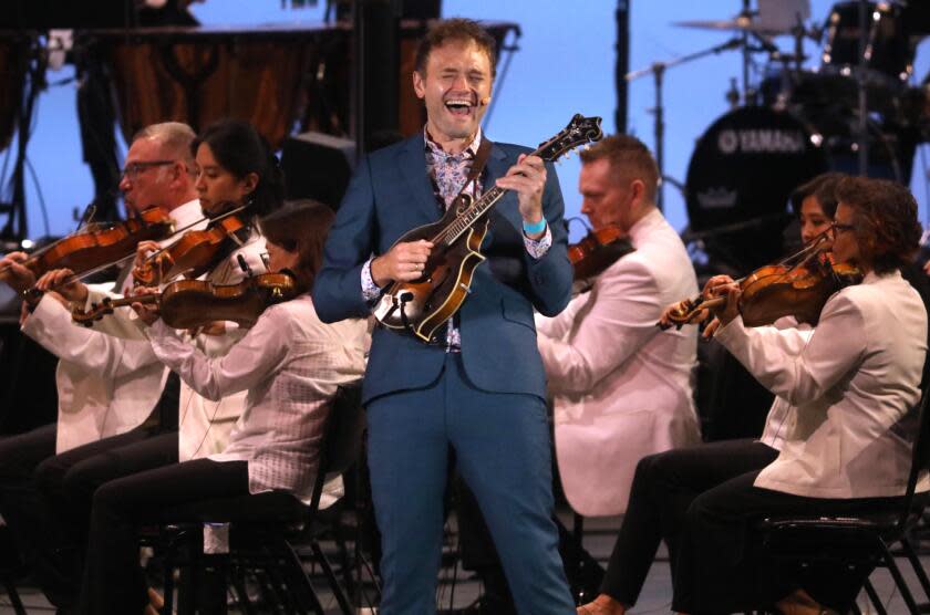 A man playing mandolins.