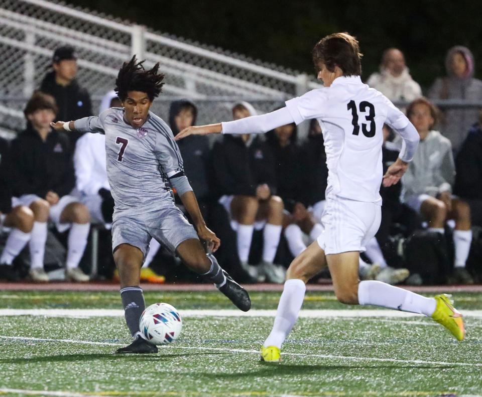 Caravel's Miles Hood (7) drives the ball away from Appoquinimink's Ryan Black in the second half of the Bucs' 1-0 win at Bob Peoples Stadium, Tuesday, Oct. 4, 2022.