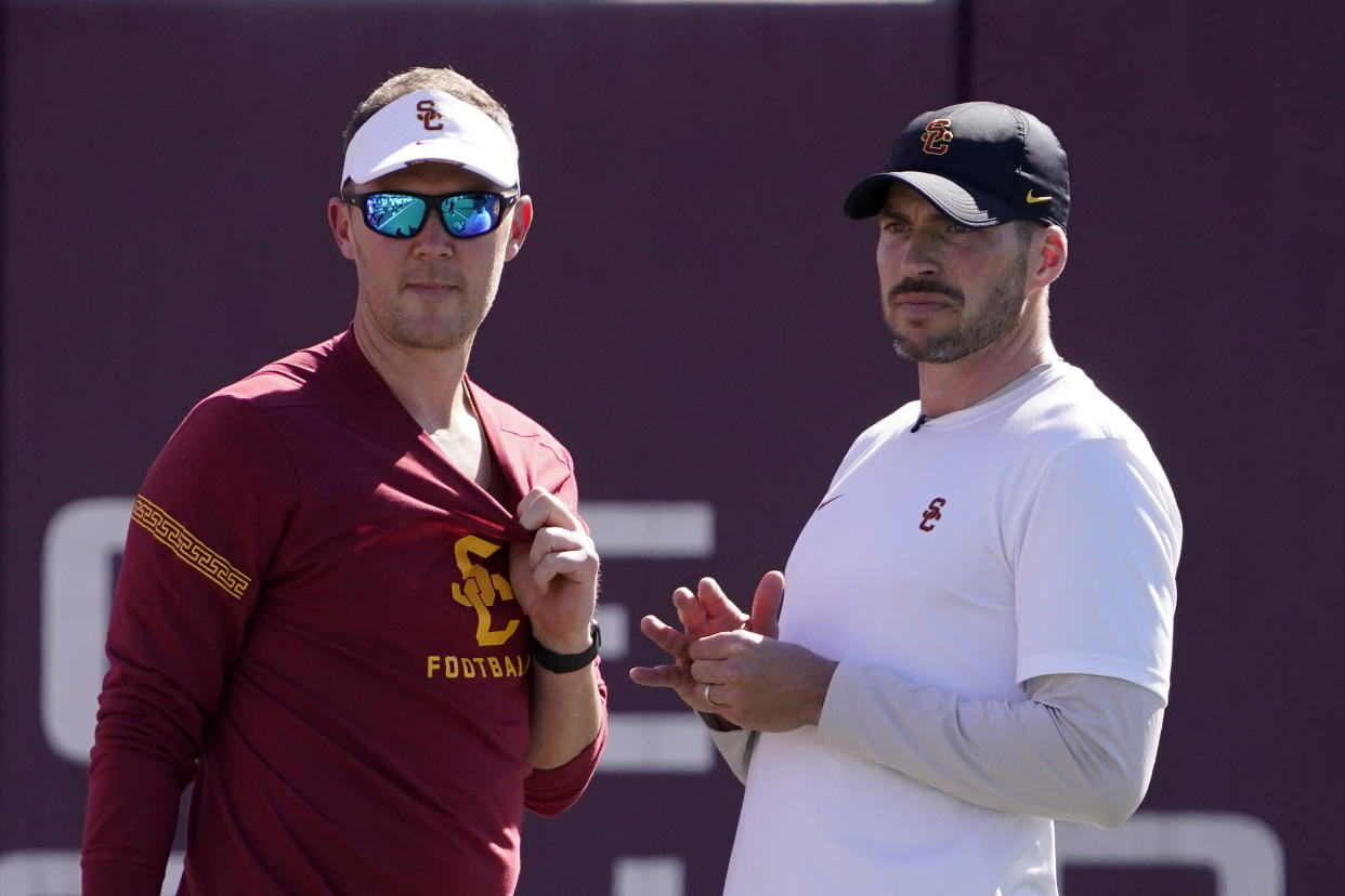 Southern California head coach Lincoln Riley, left, talks with defensive coordinator Alex Grinch during an NCAA college football practice Thursday, March 24, 2022, in Los Angeles. (AP Photo/Mark J. Terrill)