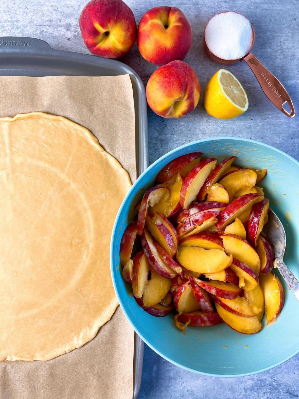 Arrange the peaches in the center of the dough (using the indentation as a guide) and work your way in, slightly overlapping the slices as you go.