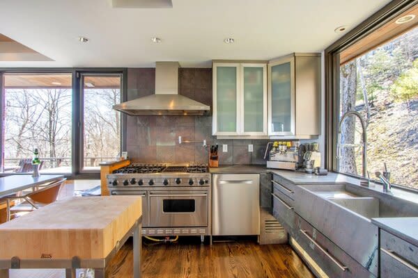 The kitchen features top-end appliances and offers access to one of the home's four decks.