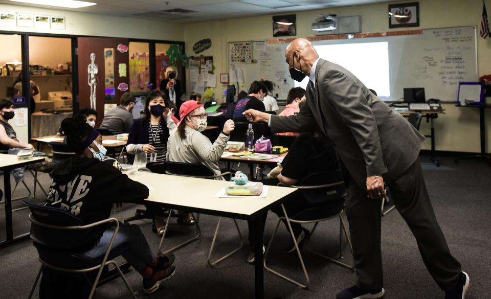 East Lansing High School Principal Andrew Wells drops into a classroom Thursday morning, May 19, 2022. After 33 years in education, Wells will retire at the end of the school year.