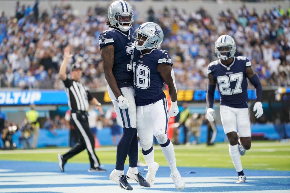 Dallas Cowboys strong safety Damontae Kazee, center right, celebrates with Trevon Diggs (7) after intercepting a pass during the second half of an NFL football game against the Los Angeles Chargers Sunday, Sept. 19, 2021, in Inglewood, Calif.