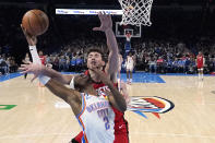 Oklahoma City Thunder guard Shai Gilgeous-Alexander (2) is fouled by Houston Rockets center Alperen Sengun, rear, in the first half of an NBA basketball game Saturday, Feb. 4, 2023, in Oklahoma City. (AP Photo/Sue Ogrocki)