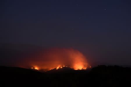 Seen in a long exposure photograph, the Soberanes Fire burns along ridges above Carmel-By-The-Sea, California, U.S. July 27, 2016. REUTERS/Noah Berger