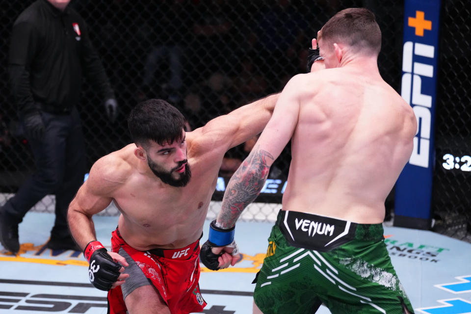 LAS VEGAS, NEVADA – DECEMBER 09: (L-R) Nasrat Haqparast of Germany punches Jamie Mullarkey of Australia in a lightweight fight during the UFC Fight Night event at UFC APEX on December 09, 2023 in Las Vegas, Nevada. (Photo by Jeff Bottari/Zuffa LLC via Getty Images)