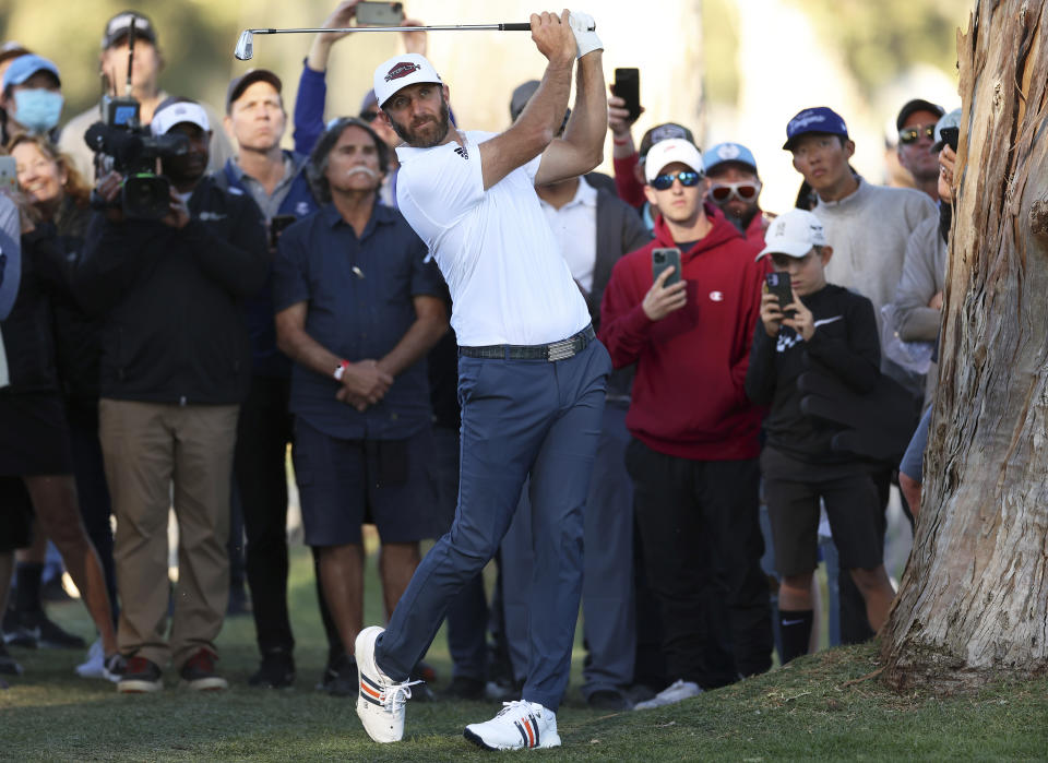 Dustin Johnson watches his second shot on the 13th hole during the first round of the Genesis Invitational golf tournament at Riviera Country Club, Thursday, Feb. 17, 2022, in the Pacific Palisades area of Los Angeles. (AP Photo/Ryan Kang)