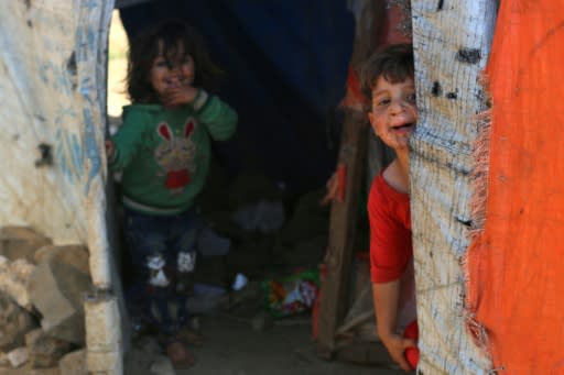 Syrian children are seen at a makeshift camp in the village of Al-Rafid near the armistice line in the Golan Heights on June 27, 2018