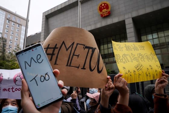 Supporters of the MeToo movement hold banners as they wait for Zhou Xiaoxuan outside at a courthouse where Zhou is appearing in a sexual harassment case in Beijing on Dec. 2, 2020. <span class="copyright">Andy Wong—AP</span>
