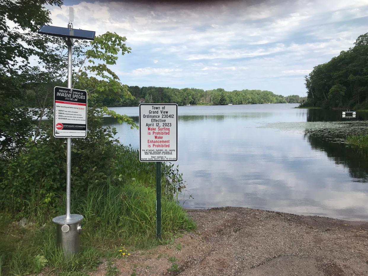 A sign installed in July 2023 at Diamond Lake in Bayfield County lists the prohibition on wake surfing. The restriction was approved earlier that year by the local town board and is part of a growing trend toward local ordinances restricting or prohibiting wake-enhanced boating in Wisconsin.