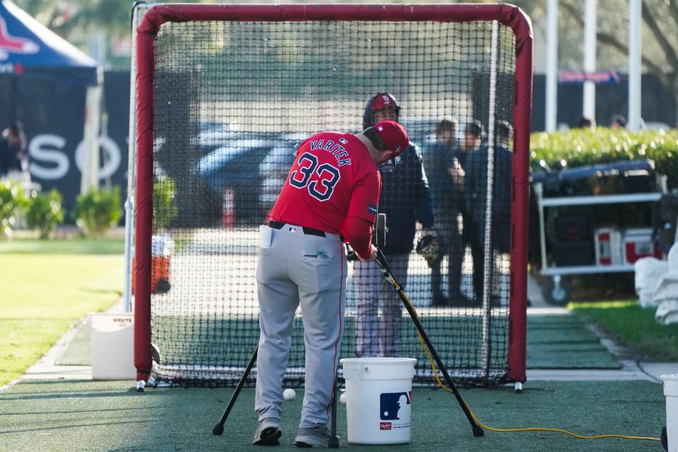 Red Sox game planning coordinator Jason Varitek calibrates a pitching machine on Wednesday as pitchers and catchers arrive for spring training.