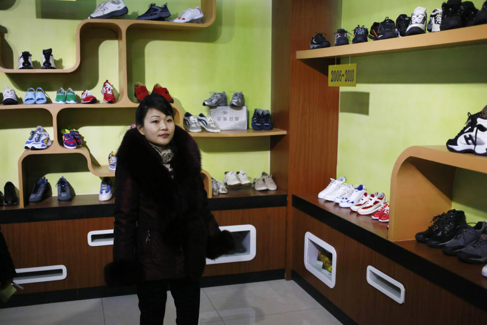 In this Friday, Feb. 1, 2019, photo, a guide stands in a product exhibition room at Ryuwon Shoe Factory that specializes in sports footwear, in Pyongyang, North Korea. North Korean pop culture, long dismissed by critics as a kitschy throwback to the dark days of Stalinism, is getting a major upgrade under leader Kim Jong Un. The changes are being seen in everything from television dramas and animation programs to the variety and packaging of consumer goods, which have improved significantly under Kim. (AP Photo/Dita Alangkara)