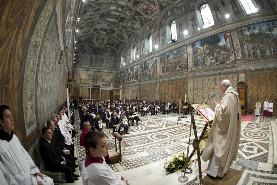 Pope Francis leads a mass where 32 babies were baptized in the Sistine Chapel at the Vatican