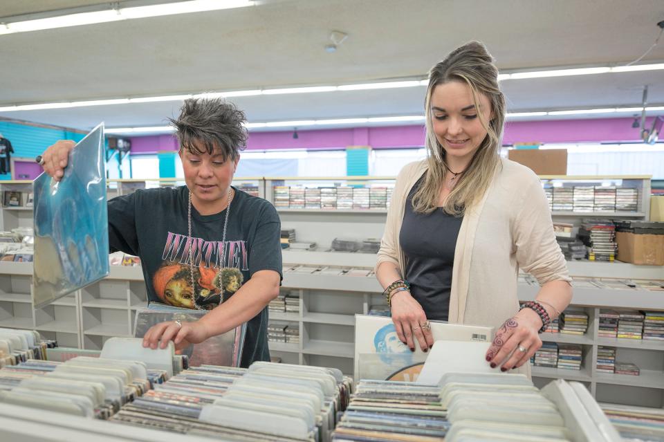 Monica Arrieta, left, and Kami Arrieta stock vinyl records while preparing their new High Vibes Music & Zen Boutique at 420 W. Fourth St. in Pueblo, Colo., on Thursday, May 4, 2023.
