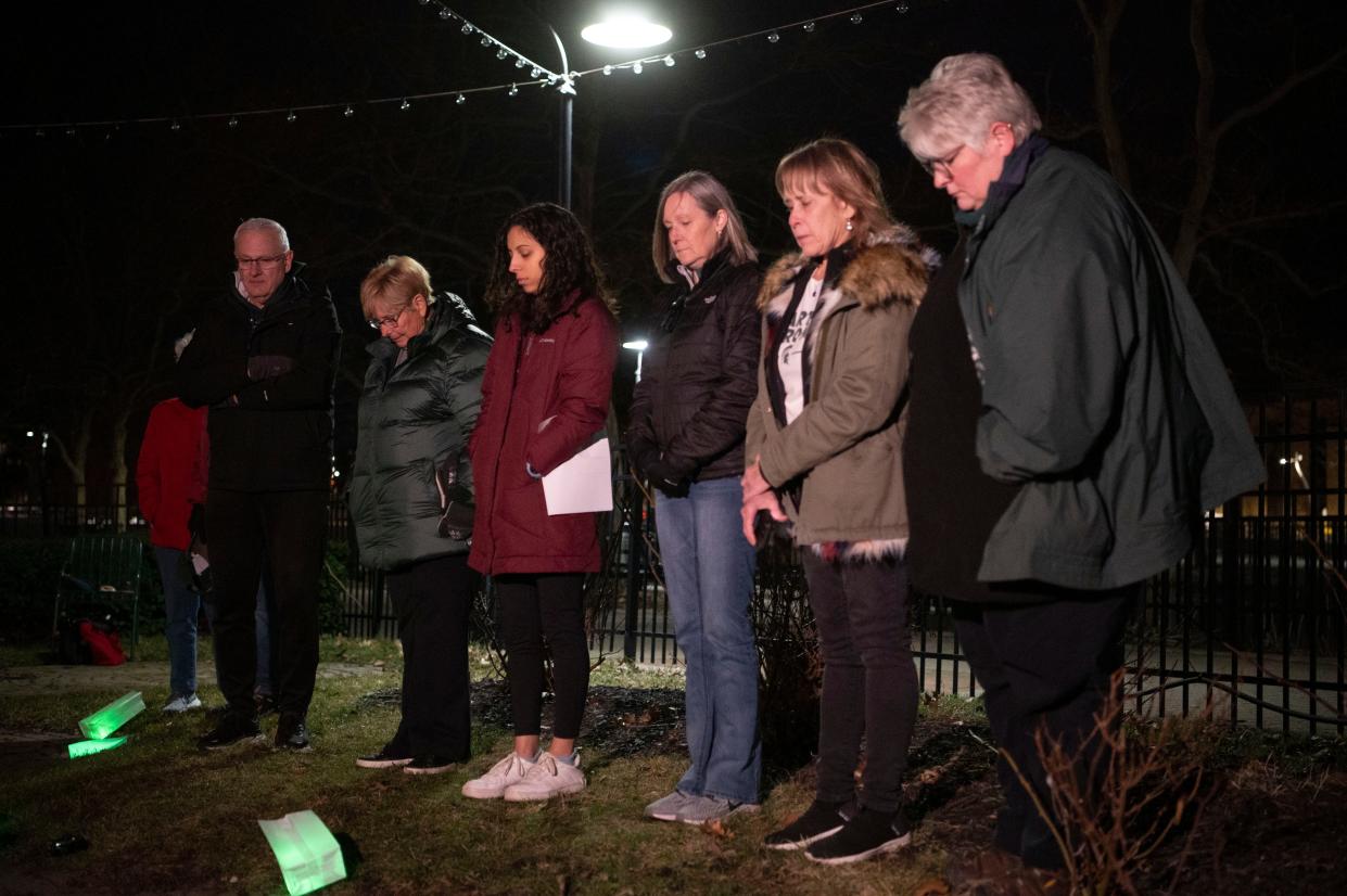 Calhoun County Spartans members and guests observe a moment of silence commemorating the anniversary of the Michigan State University mass shooting during a vigil at Clara's in Battle Creek on Tuesday, Feb. 13, 2024.