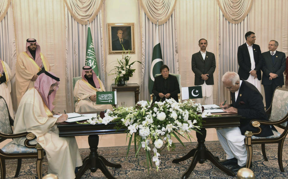 In this photo released by the Press Information Department, visiting Saudi Arabia's Crown Prince Mohammed bin Salman, center left, and Pakistani Prime Minister Imran Khan, center right, witness the signing ceremony of the Memorandum of Understanding (MOU) on Petroleum, in Islamabad, Pakistan, Sunday, Feb. 17, 2019. Saudi Arabia's powerful Crown Prince Mohammed bin Salman began his four-day regional visit on Sunday, arriving in Pakistan where he is expected to sign agreements worth billions of dollars to help the Islamic nation overcome its financial crisis. (Press Information Department via AP)