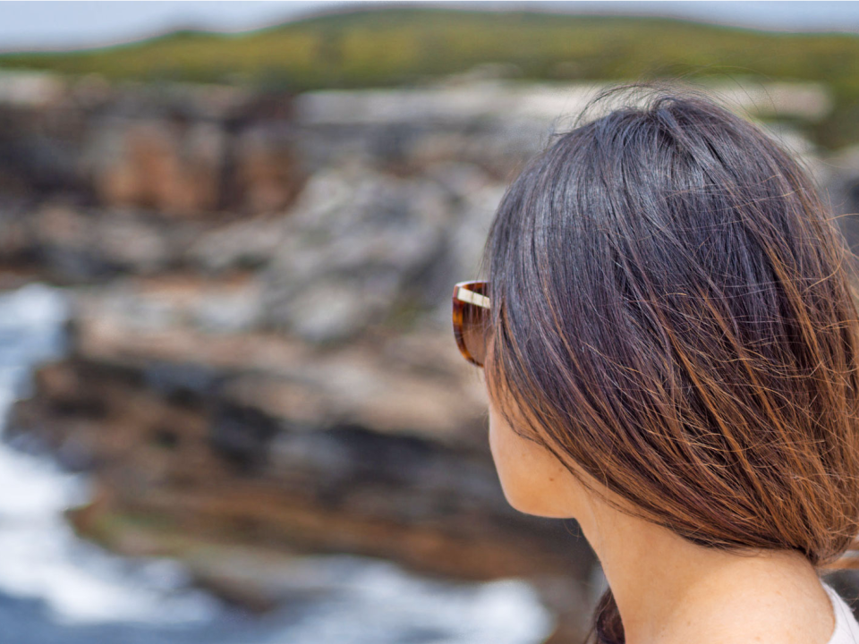 woman thinking overlooking ocean