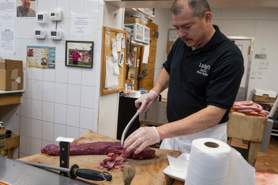 Butcher Nervin Ramirez prepares meat for customers. Luigi's Deli, Butcher Shop & Catering is a third-generation deli and meat market that recently celebrated its 50th anniversary.  South Toms River, NJFriday, May 12, 2023