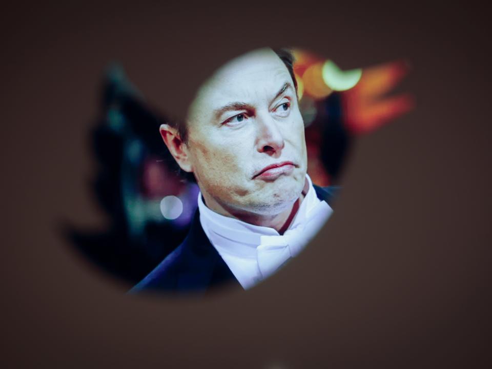 Elon Musk and a Twitter logo are seen in this illustration photo in Warsaw, Poland on 30 November, 2022. The revamped Blue Twitter subscription might not be available as in-app purchase on Apple devices when it eventually relaunches. The decision presumably was made so that Twitter can dodge Apples 30 percent cut of App Store purchases. While Elon Musk is publicly tweeting his displeasure with Apple, it appears he wants to avoid having to pay Apples fees. (Photo by STR/NurPhoto via Getty Images)