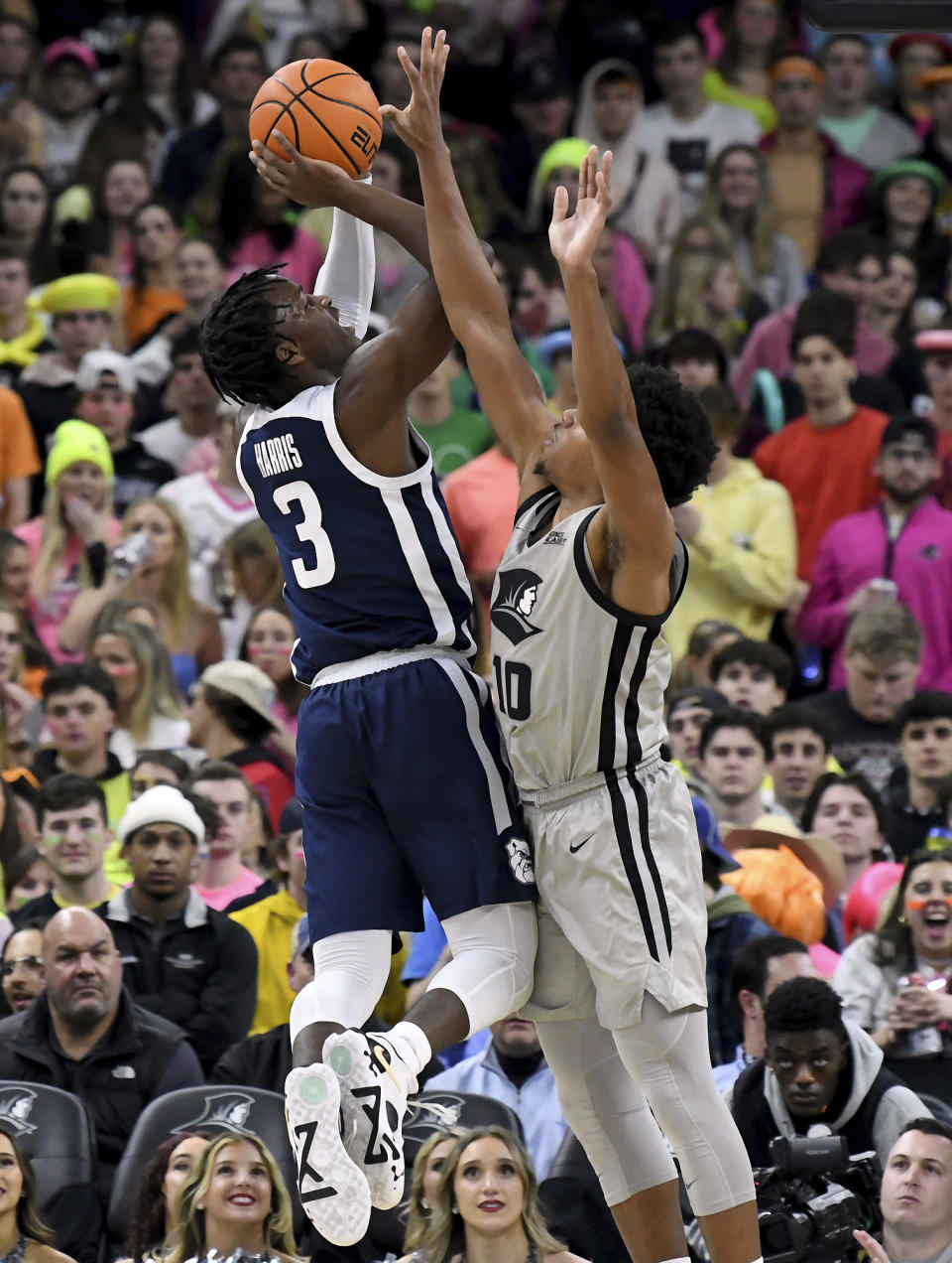 Providence's Noah Locke (10) attempts to block a shot by Butler's Chuck Harris (3) during the first half of an NCAA college basketball game, Wednesday, Jan. 25, 2023, in Providence, R.I. (AP Photo/Mark Stockwell)