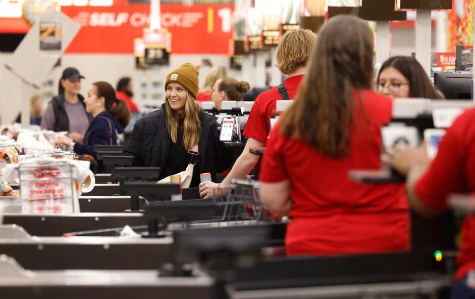 Customers check out at the registers of the Fort Worth Alliance H-E-B on Wednesday