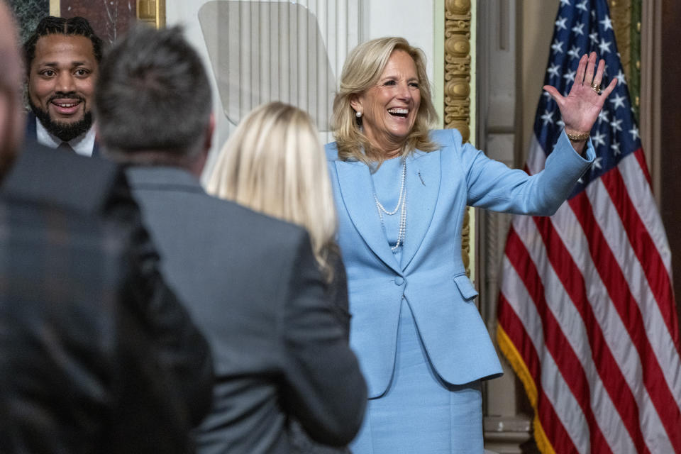 First lady Jill Biden waves as she arrives, next to Greg Jackson, deputy director of the White House Office of Gun Violence Prevention, for an event with K-12 principals about guns, in the Eisenhower Executive Office Building, Thursday, Jan. 25, 2024, on the White House complex in Washington. (AP Photo/Jacquelyn Martin)