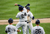 New York Yankees' Gio Urshela, top right, celebrates with teammate Gary Sanchez (24) after hitting a grand slam off Boston Red Sox starting pitcher Zack Godley in the second inning of a baseball game Saturday, Aug. 1, 2020, in New York. (AP Photo/John Minchillo)