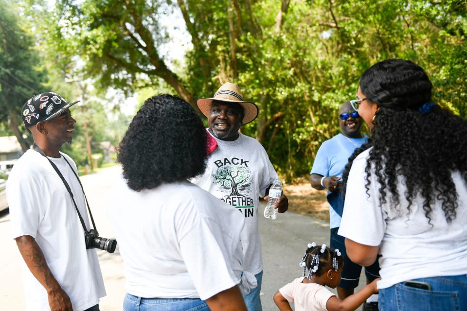 Henry Thomas visits with old friends during a neighborhood reunion in Walterboro, S.C., on Saturday, July 1, 2023. This is Henry's first visit back to Walterboro since being incarcerated, and the first time seeing many of his family members and friends since his sentence.