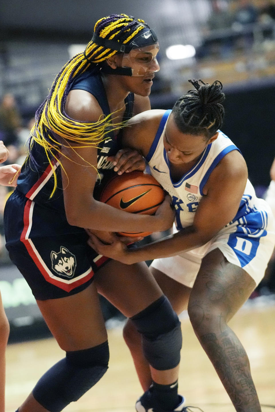 Connecticut forward Aaliyah Edwards, left, and Duke guard Jordyn Oliver, right, battle for the ball during the first half of an NCAA college basketball game in the Phil Knight Legacy tournament Friday, Nov. 25, 2022, in Portland, Ore. (AP Photo/Rick Bowmer)