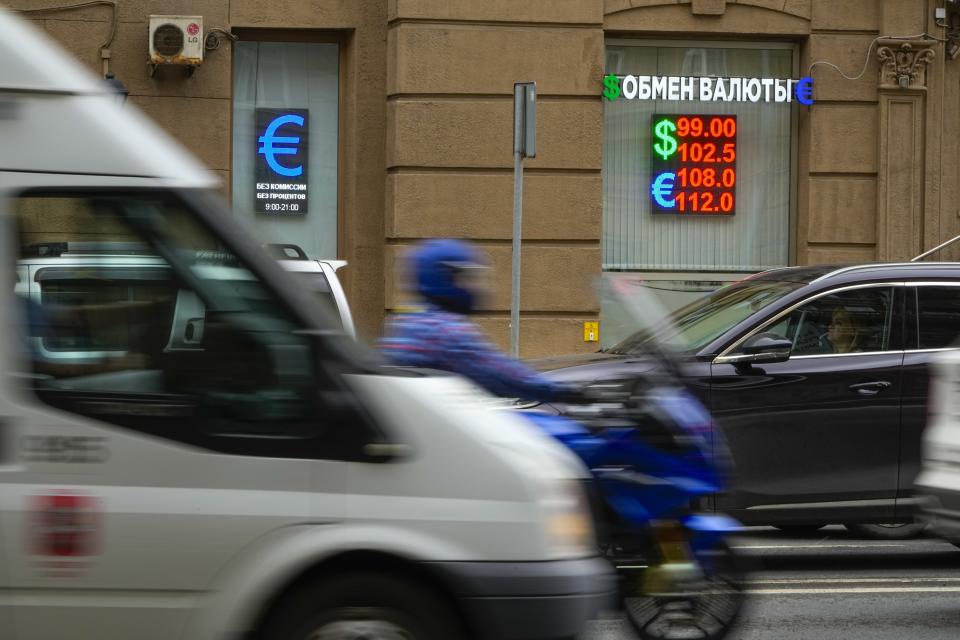 Vehicles drive past a currency exchange office in Moscow, Russia, Monday, Aug. 14, 2023. The Russian ruble has reached its lowest value since the early weeks of the war in Ukraine as Western sanctions weigh on energy exports and weaken demand for the national currency. The Russian currency passed 101 rubles to the dollar on Monday, continuing a more than 25% decline in its value since the beginning of the year. (AP Photo/Alexander Zemlianichenko)