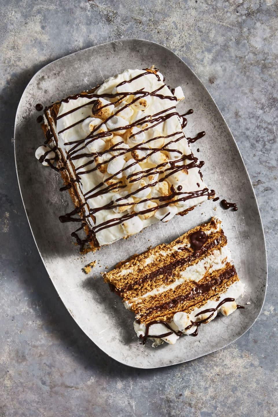 s'mores icebox cake with chocolate syrup drizzled on top