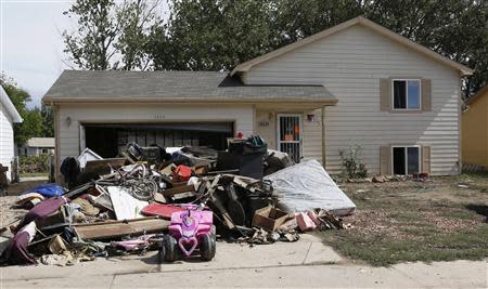 The contents of a home damaged by a flood is seen in the driveway, in Evans, Colorado September 23, 2013. REUTERS/Rick Wilking