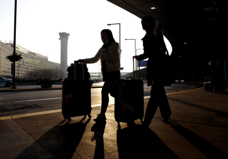 FILE - In this Wednesday, Nov. 23, 2011, file photo, travelers, with luggage in hand, make their way toward Terminal A at O'Hare International Airport in Chicago. The U.S Department of Homeland Security said Wednesday, Feb. 19, 2014, it is warning airlines that terrorists could try to hide explosives in shoes. It's the second time in less than three weeks that the government has issued a warning about possible attempts to smuggle explosives on a commercial jetliner. (AP Photo/Nam Y. Huh, File)