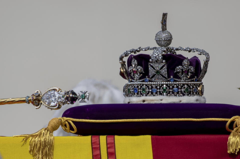 FILE - The Sovereign's Scepter with Cross, left, and the Imperial State Crown, sit on the coffin of Queen Elizabeth II as it passes through Horse Guards Parade during her state funeral in London, Monday, Sept. 19, 2022. Two stones cut from the Cullinan Diamond, the largest rough diamond ever found, will feature prominently in King Charles III coronation ceremony on Saturday, May 6, 2023. Cullinan I, a huge drop-shaped stone weighing 530.2 carats, is mounted in the Sovereign’s Sceptre with Cross. Cullinan II, a cushion-shaped gem of 317.4 carats, is mounted on the front of the Imperial State Crown that Charles will wear as he leaves Westminster Abbey. (Chris J Ratcliffe/Pool Photo via AP, File)