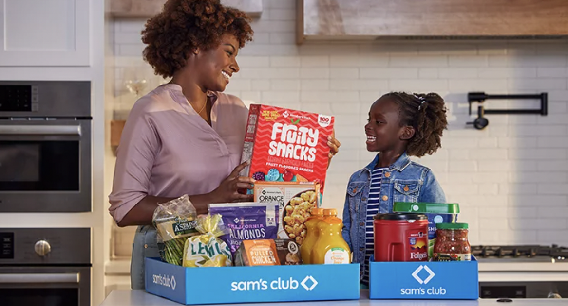 smiling family with kitchen products from Sam's Club