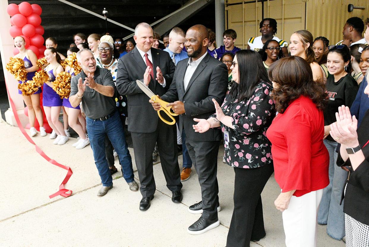 Caddo Parish Public Schools' Superintendent, Dr. T. Lamar Goree cuts the red ribbon during the celebration of the Lee Hedges Stadium renovations Thursday morning, May 9, 2024.