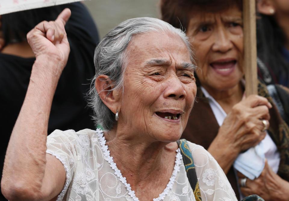 Alleged Filipino "comfort woman" Narcisa Claveria, 87, gestures as she addresses supporters during a rally outside the Japanese Embassy to protest the two-day visit of Japanese Prime Minister Shinzo Abe, Thursday, Jan. 12, 2017, in suburban Pasay city south of Manila, Philippines. The "comfort women," allegedly forced by Japanese forces to be sex slaves during WWII, are calling on President Rodrigo Duterte to bring up their plight in his meeting with Prime Minister Abe. (AP Photo/Bullit Marquez)