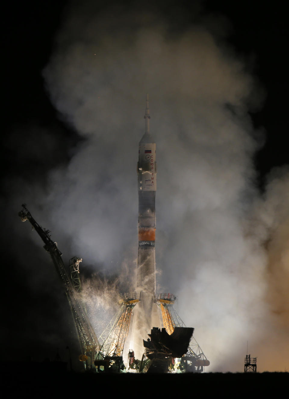 The Soyuz-FG rocket booster with Soyuz TMA-12M space ship carrying a new crew to the International Space Station (ISS) blasts off at the Russian leased Baikonur cosmodrome, Kazakhstan, Wednesday, March 26, 2014. The Russian rocket carries astronaut Steven Swanson, Russian cosmonauts Alexander Skvortsov and Oleg Artemyev. (AP Photo/Dmitry Lovetsky)