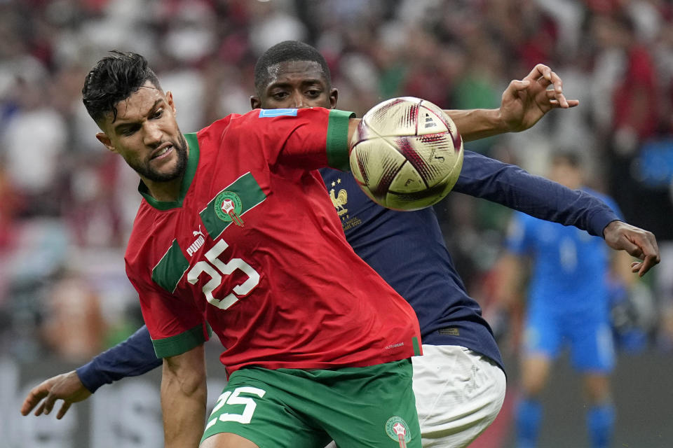 FILE - France's Ousmane Dembele, background, and Morocco's Yahia Attiyat Allah challenge for the ball during the World Cup semifinal soccer match between France and Morocco at the Al Bayt Stadium in Al Khor, Qatar, on Dec. 14, 2022. Nigeria and South Africa were drawn in the same World Cup qualifying group on Thursday July 13, 2023 in a re-shaped African competition that will lead to at least nine teams at the 2026 showpiece in the U.S., Canada and Mexico. (AP Photo/Martin Meissner, File)