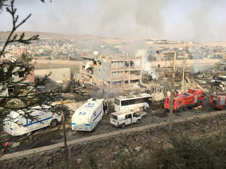 Turkish police and firefighters parked near a destroyed police headquarters in Cizre, southeastern Turkey, after a car bombing on August 26, 2016